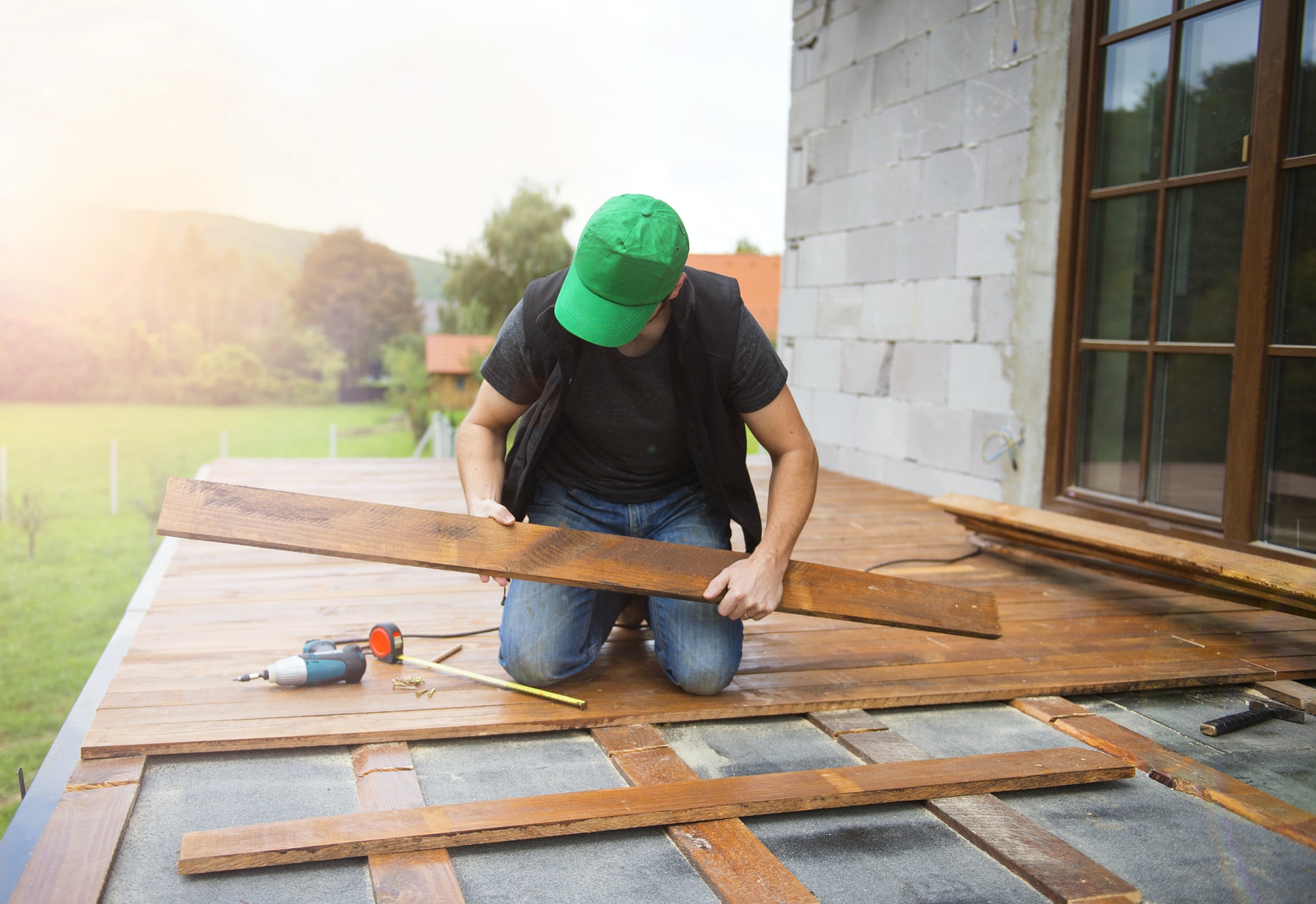 Handyman installing wooden flooring