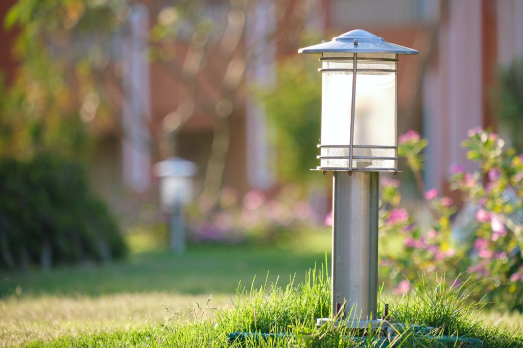 Outdoor lamp on yard lawn for garden lighting in summer park