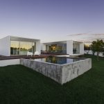 Modern house with garden swimming pool and wooden deck